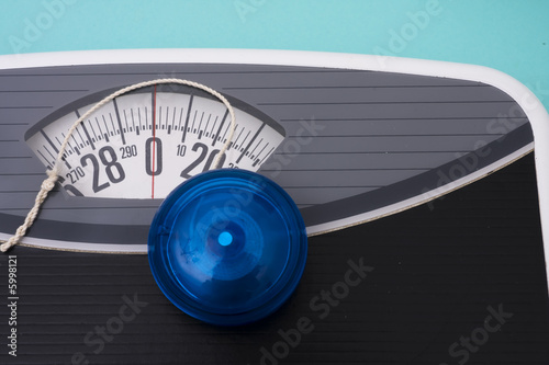 Photos Blue yo-yo sitting on scales on blue background