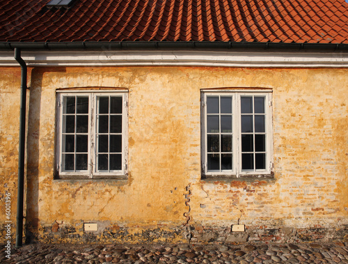 old traditional house in denmark with ocre colour wall.