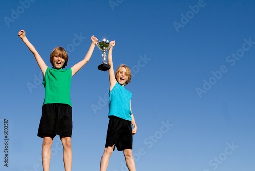 children winners with sports cup or trophy
