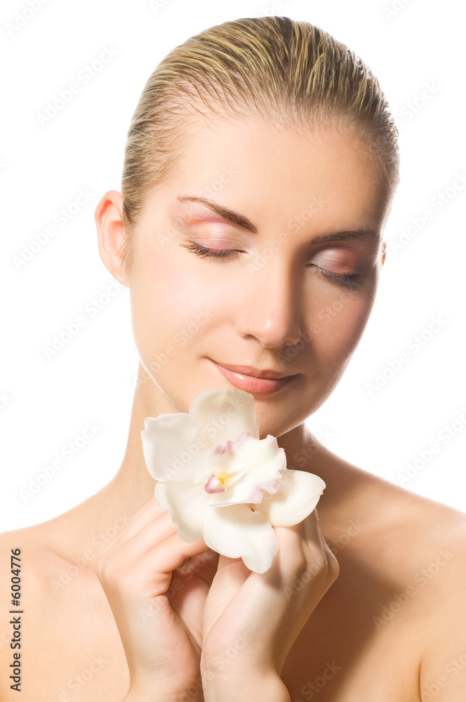 Beautiful girl holding orchid flower in her hands Beautiful girl holding orchid flower in her hands