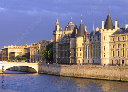 Palace Conciergerie riverside at overcast sunset