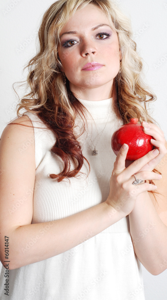 beautiful woman is holding a fruit in her hands beautiful woman is holding a fruit in her hands