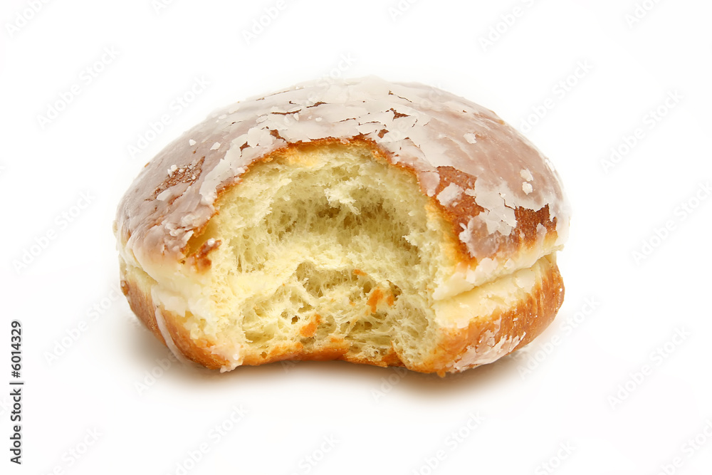 Delicious donut with a chunk bitten out isolated on white