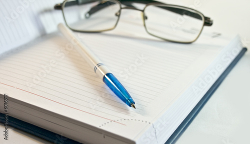 notebook, pen,glasses