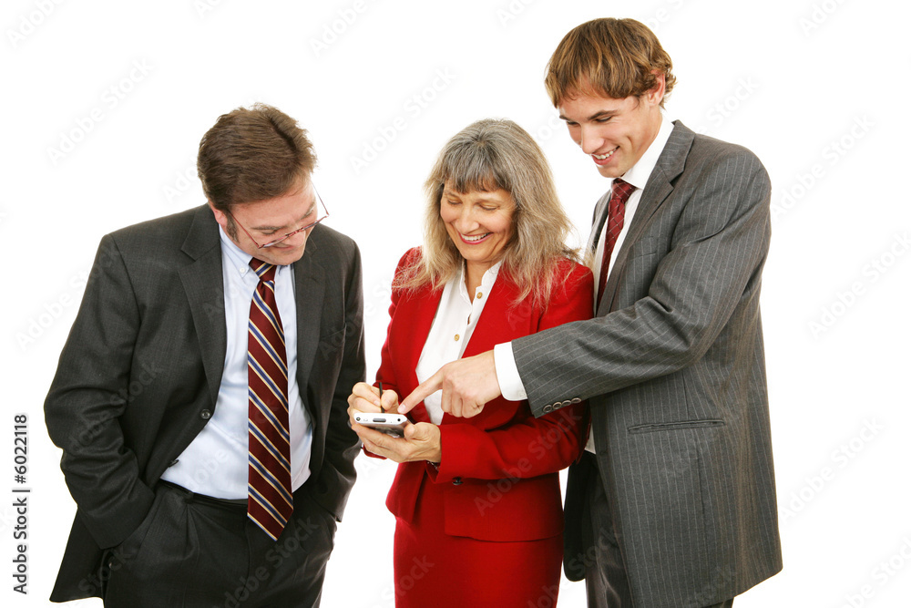 Business team enjoying a handheld electronic game. Business team enjoying a handheld electronic game.