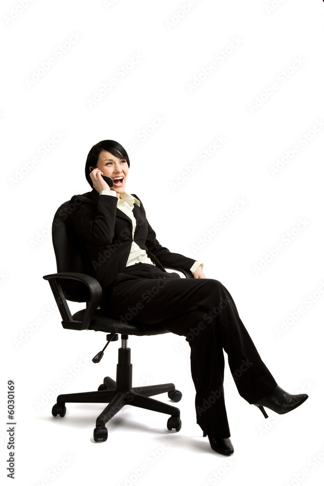 An businesswoman sitting on a chair and talking on the phone An businesswoman sitting on a chair and talking on the phone