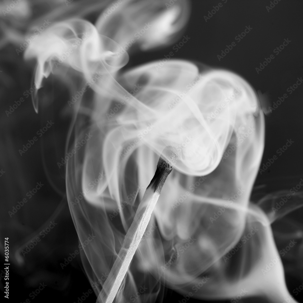 close up of smoke swirling around match close up of smoke swirling around match