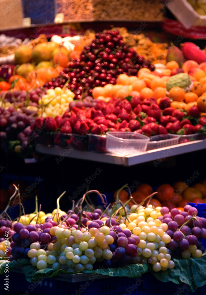 A street market with a range of fruits for sale.