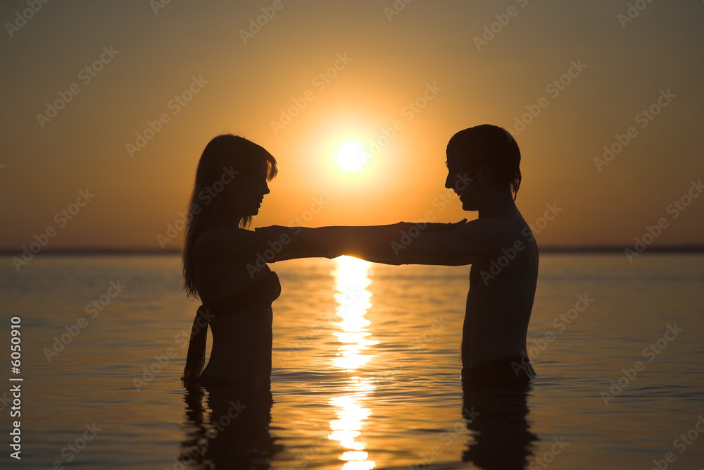 couple of happy lovers on the evening beach