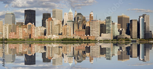Panorama of Manhattan skyline with water reflection