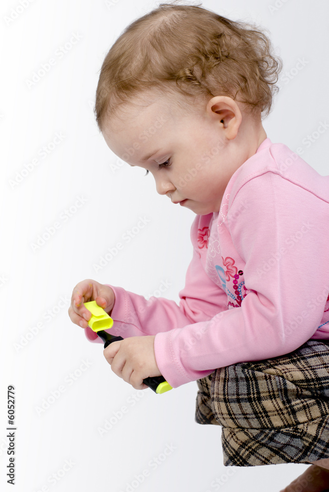 a sitting girl with dirty fingers is playing with a pencil a sitting girl with dirty fingers is playing with a pencil