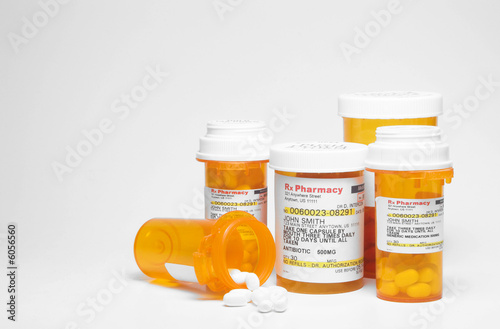 Prescription pills in plastic medicine bottles.