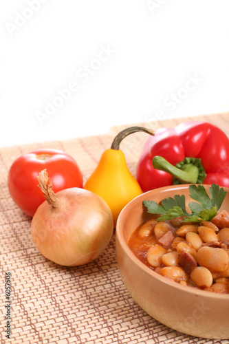 Delicious beans with sausages and tomatoes.