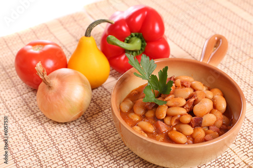 Delicious beans with sausages and tomatoes.