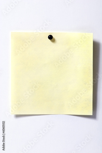 A small yellow post it ready to fill out. white background