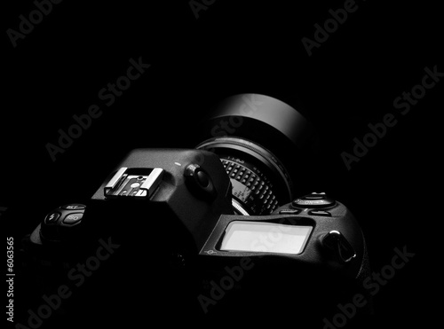 SLR camera on black spot light