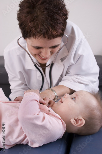 Doctor smiling at a seven month old baby girl.