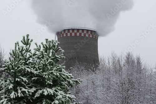 Smoking industrial pipe in a winter landscape