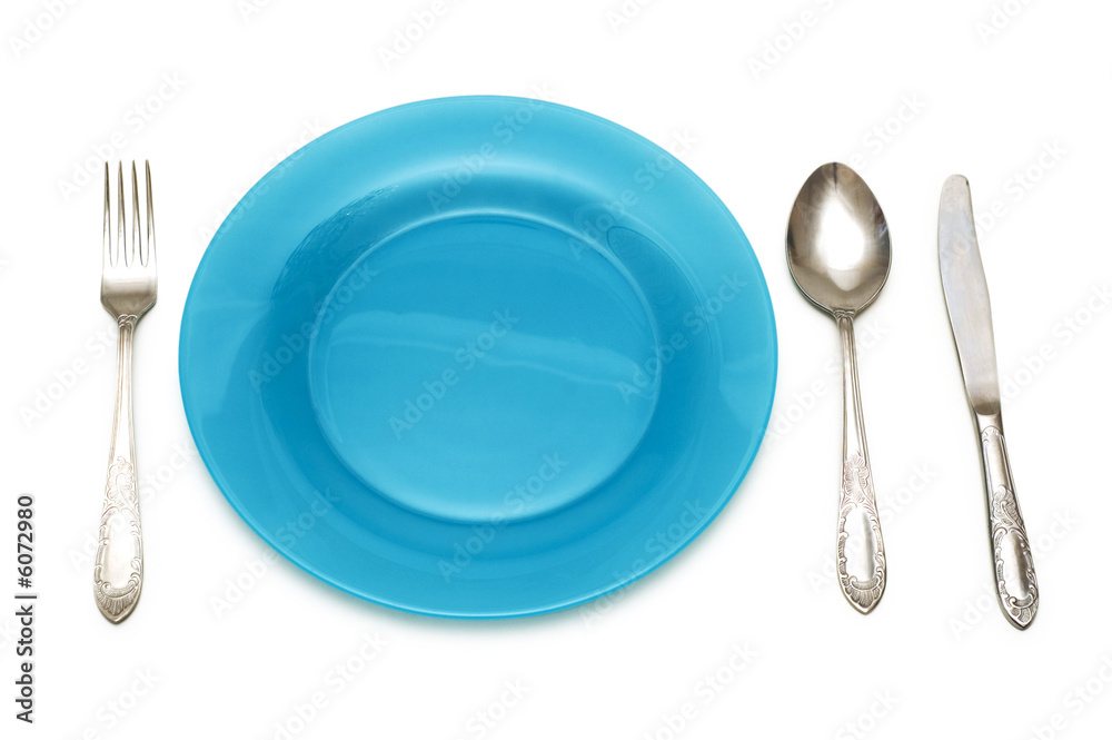 Blue plate and table utensils isolated on white Blue plate and table utensils isolated on white