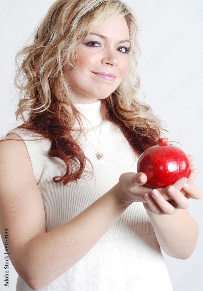 beautiful woman is holding a fruit in her hands beautiful woman is holding a fruit in her hands