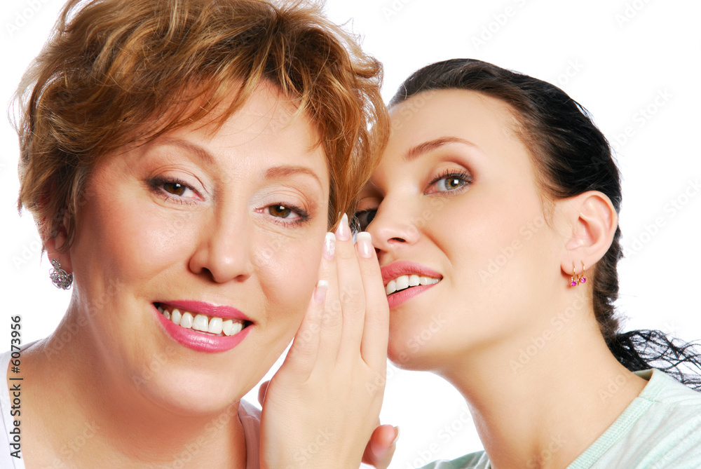 Young woman whispering in the ear Young woman whispering in the ear