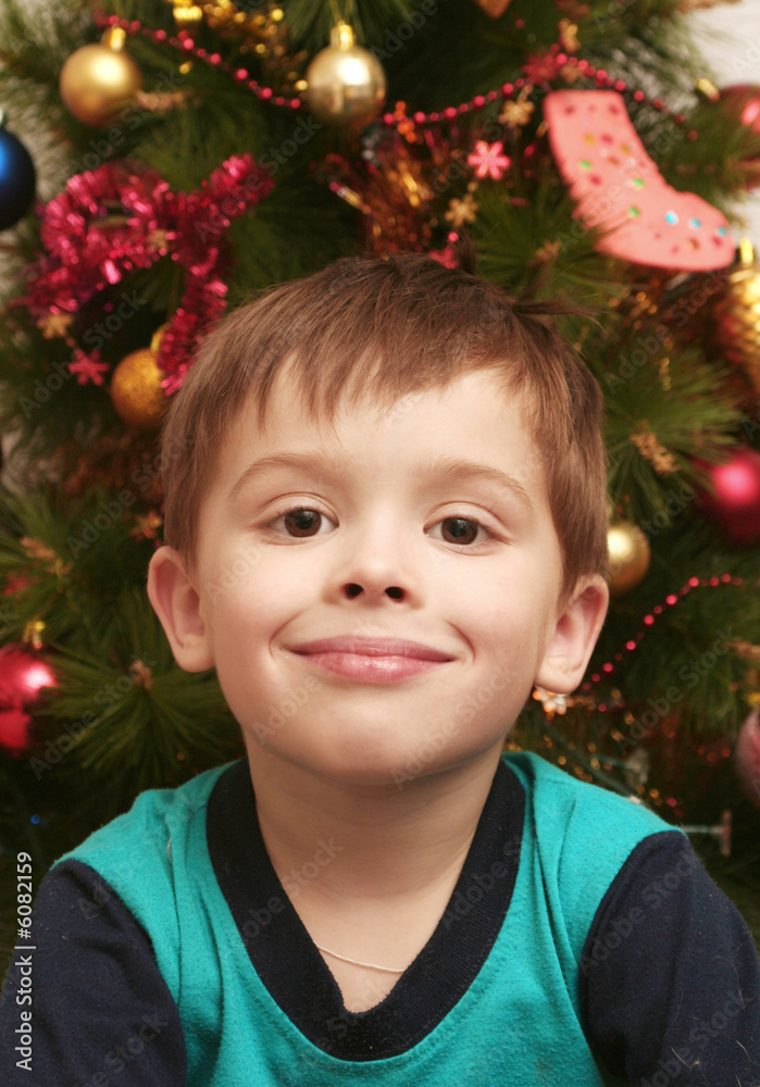The happy child on a background of a New Year tree The happy child on a background of a New Year tree