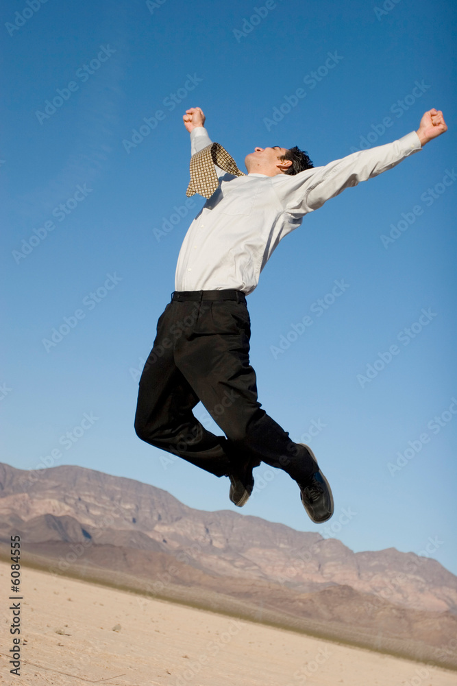 Happy businessman jumping in the air Happy businessman jumping in the air