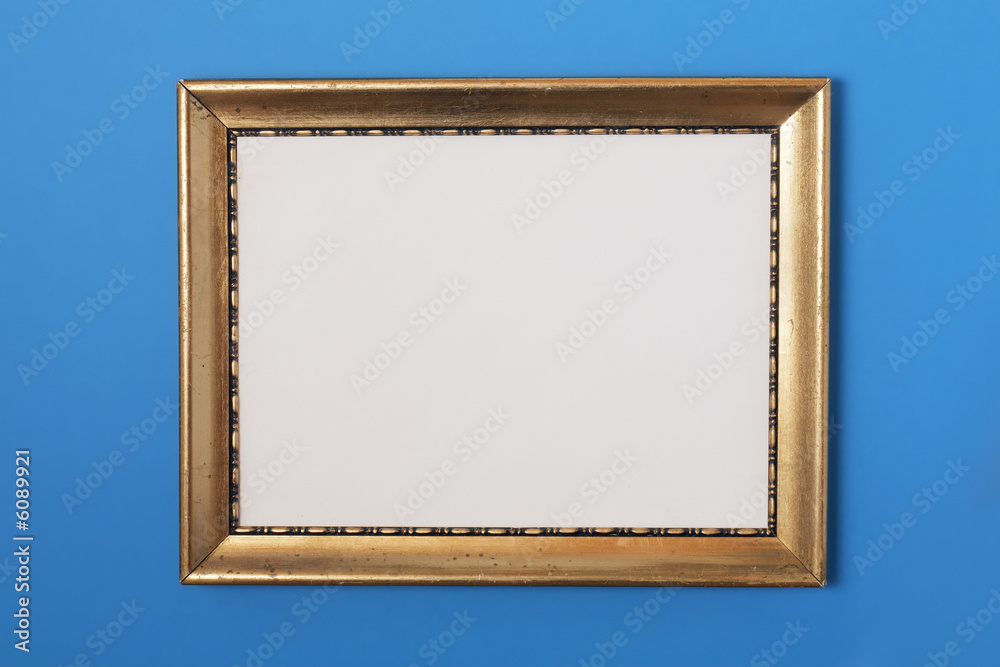 Fototapeta premium Old golden photo frame on blue