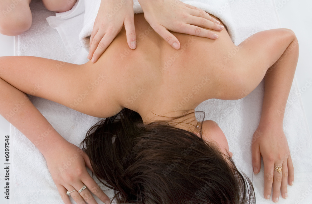 Pampered young woman with male hands doing a massage Pampered young woman with male hands doing a massage