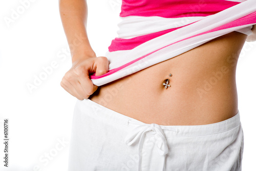 A woman shows off her belly button piercing photo