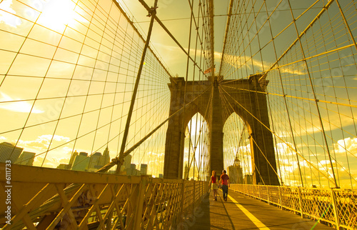 a couple walking across the Brooklyn Bridge