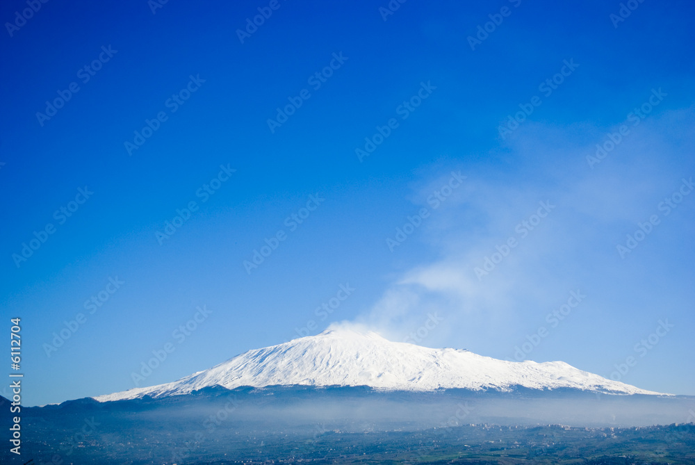 The volcano Etna on a background of the blue sky