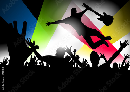 Music star jumping with the guitar in a concert