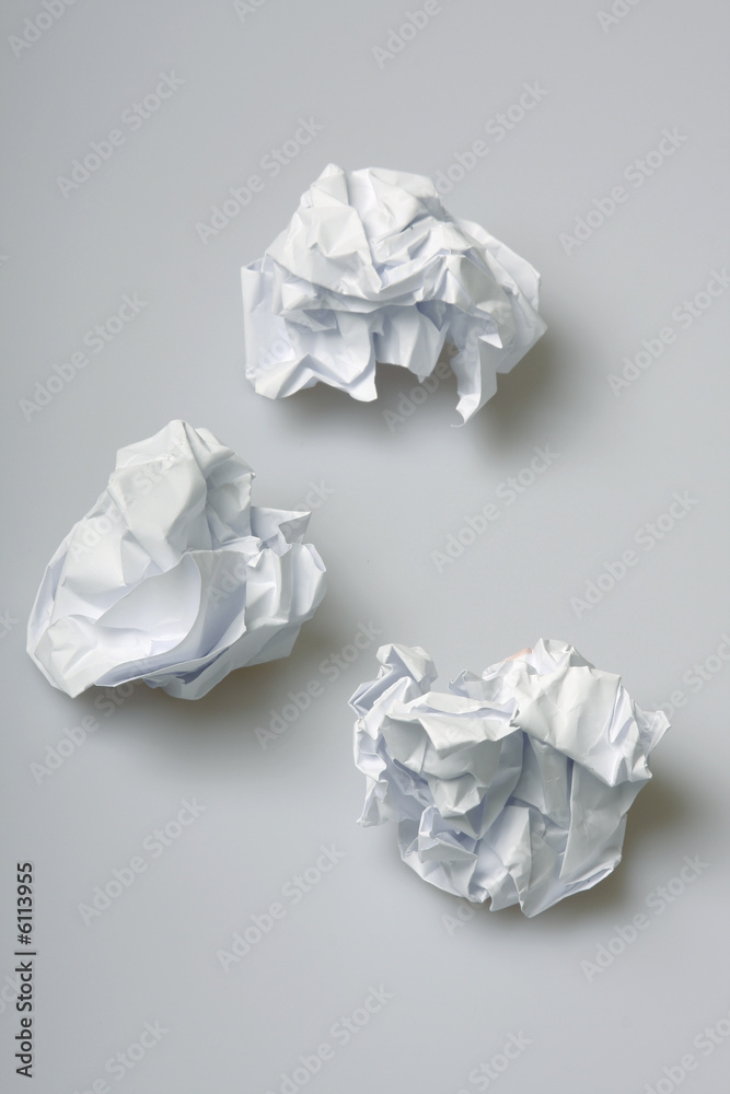 Crumpled paper wads on the floor concept for creative block Stock