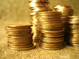 Stack of golden coins on yellow background