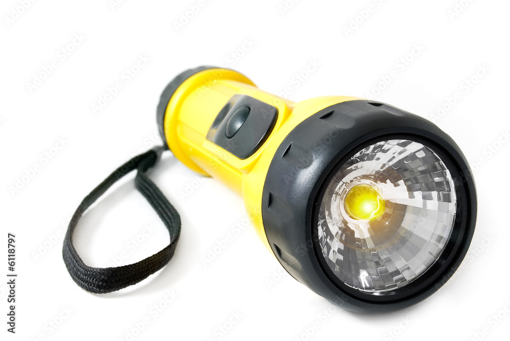 The electric torch lays on a white background. The electric torch lays on a white background.