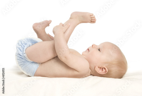 A small baby girl lying on a blanket