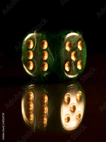 Beautiful green dice with golden dots, for successful gambling.