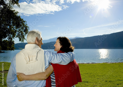 attractive married mature couple enjoying the sunset. photo