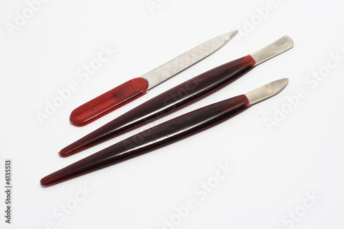 three brown manicure tools