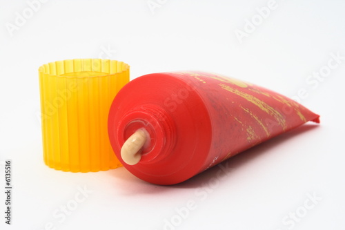 Sun-tanning cream in red tube