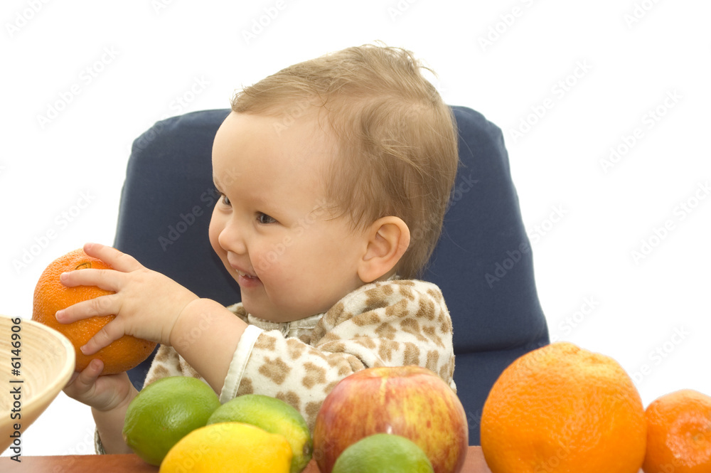 Baby and fresh fruits on table isolated background Baby and fresh fruits on table isolated background