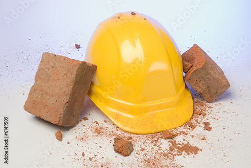 depiction of a hardhat breaking the fall of a brick