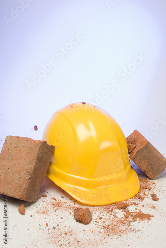 depiction of a hardhat breaking the fall of a brick