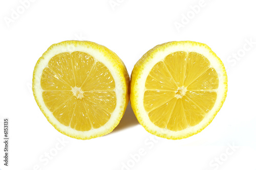 two halfs of yellow ripe lemon on white background