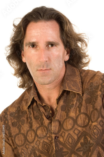 Studio portrait of mid aged man with long hair