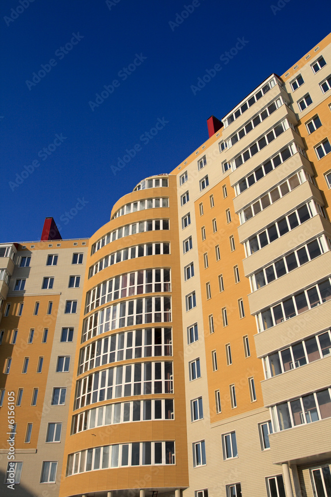 Fototapeta premium The orange monolith new-built on the sky background