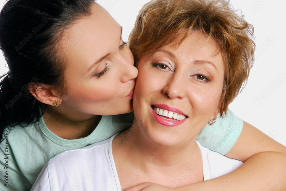 Yuong adult daughter kissing her senior mother Yuong adult daughter kissing her senior mother