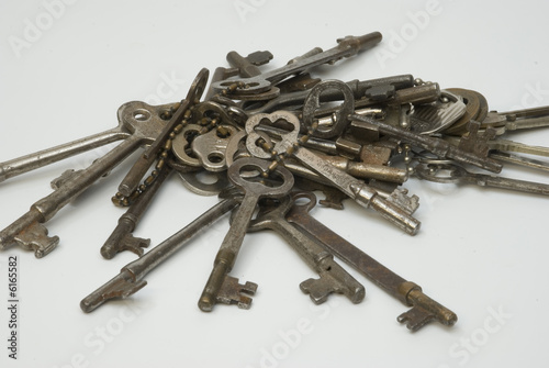 Bundle of old keys on a white background