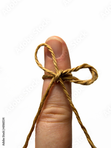 brown string tied as reminder